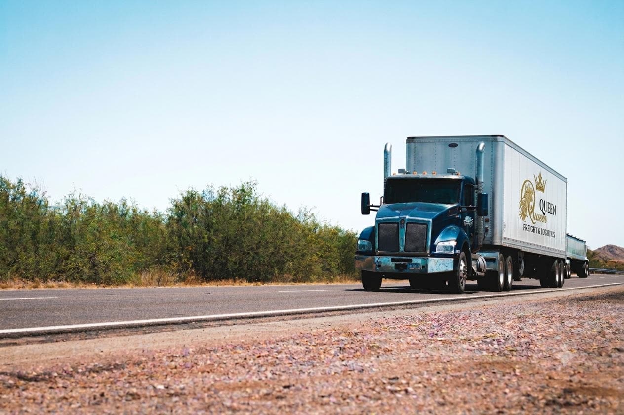 Semi truck hauling freight on an open highway